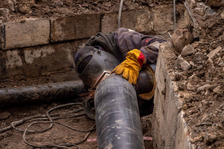Close-up view of a drainage pipe being relined in a residential garden in Leatherhead